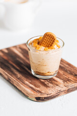 Caramel cheesecake in glass with biscuit 
