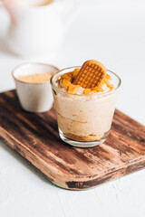Caramel cheesecake in glass with biscuit 