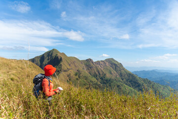 happy woman hiking on top mountain at Khao Chang Phuak, Thongphaphoom National Park, Kanchanaburi...