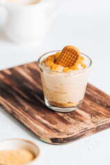 Caramel cheesecake in glass with biscuit 