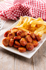 traditional German currywurst on rustic wooden table. typical oktoberfest food