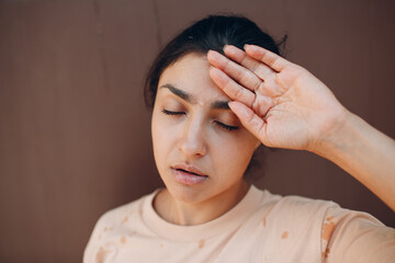 Stressed woman suffering of heatstroke refreshing with cold water outside. Weather abnormal heat...