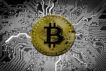 Bitcoin BTC crypto currency gold coins on a mainboard, new virtual money concept. Mining or blockchain technology