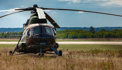 helicopter standing in the field under the sun