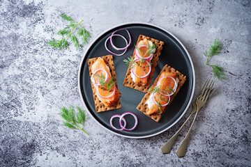 Picked salmon cream cheese rye bread in a plate