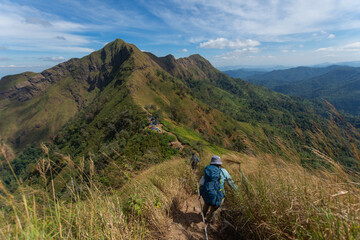 happy woman hiking on top mountain at Khao Chang Phuak, Thongphaphoom National Park, Kanchanaburi...