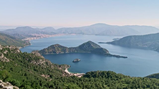 Flying over a cliff in the turkish bay of Marmaris overlooking the island and the city