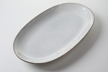 Handmade empty clean white oval pottery plate or platter