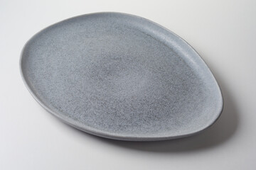 Elliptical modern grey empty ceramic plate for food placement