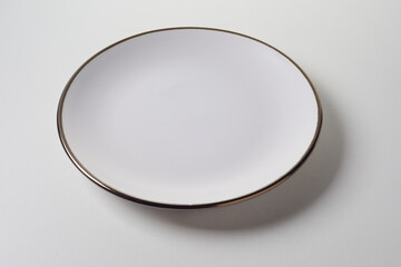 Clean empty white ceramic plate for food placement
