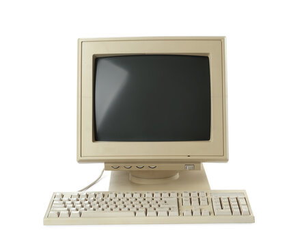 Old computer monitor and keyboard on white background