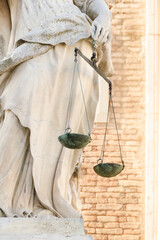 Scales of justice in hand at the marble statue