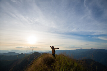 happy woman hiking on top mountain at Khao Chang Phuak, Thongphaphoom National Park, Kanchanaburi...