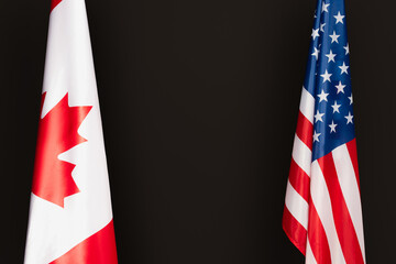 Canadian and american flags isolated on black