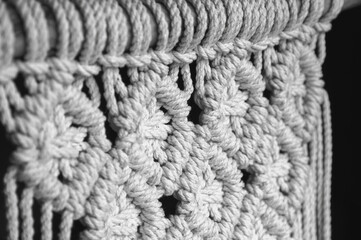 Close-up of hand made macrame texture pattern. Handmade stylish 100 cotton wall macrame decoration.