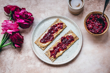 Peanut butter and cranberry jam on crackers