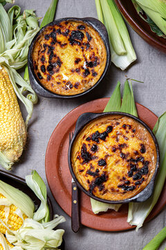 Latin American Chilean baked copn pie Pastel de Choklo in autentical clay bowls. Top view
