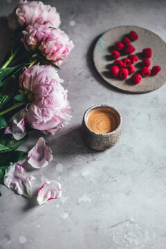 Cup of coffee on grey background with flowers