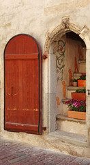 old wooden door and a colorful entrance with flowers, Tallinn, Estonia
