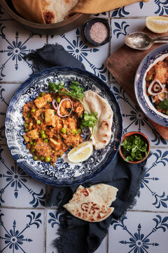 A Vegetarian Indian dish on a tiled kitchen table - Matar Paneer