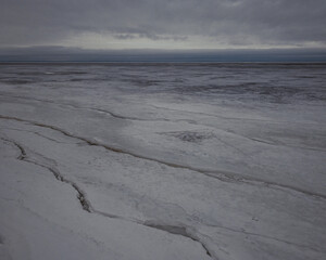 Abstract nature summer or spring ocean sea background. Small waves on golden warm water surface in motion blur with bokeh lights from sunset. Holiday, vacation and recreational background concept
