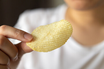 Hand hold potato chips ready to eat