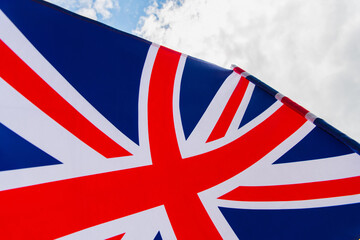 close up view of national flag of united kingdom with red cross against sky