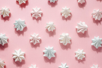 Pink and white meringue, zephyr, marshmallow, on pink background, selective focus