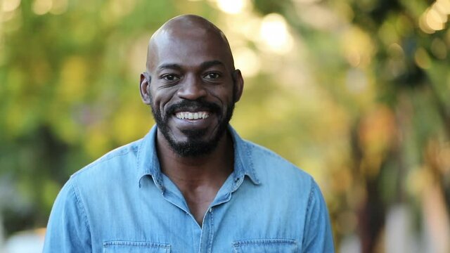 African black man portrait face smiling close-up standing outside