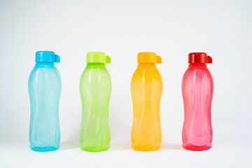 Four different colour of tupperware bottles