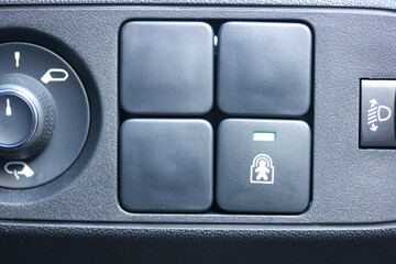 Various buttons in a car, including blanks and child lock