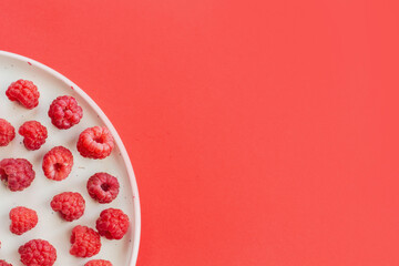 Ripe raspberry fruits on plate, healthy pile of summer berries  top view. Pattern flat lay of red...