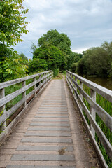 Obraz na płótnie Canvas Kintbury, Berkshire, UK. 2021, A pedestrian only footbridge crossing a waterway alongside the Kennet and Avon Canal.