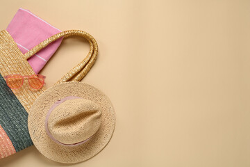 Flat lay composition with straw hat on beige background. Space for text