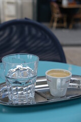 A close-up of expresso on a Parisian terrace.
