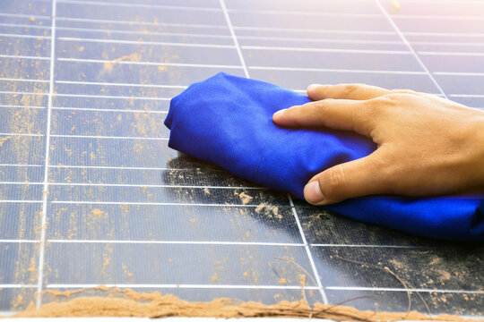 Mini solar cell panel cleaning by using clothes and water to clean.