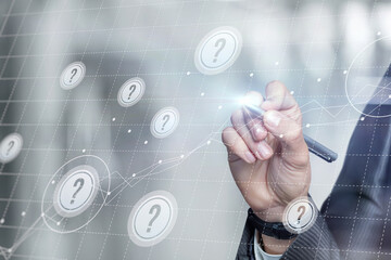 Businessman working with questions on a virtual computer screen.