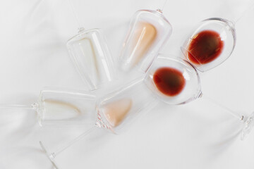 Flat lay with glasses with different wine on white background.