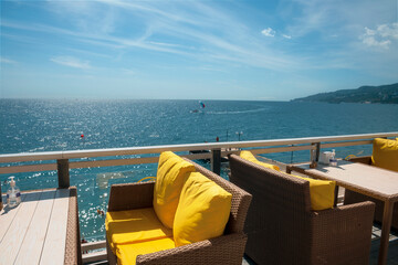 Obraz premium wicker willow chairs and wooden tables in a seaside cafe on the Black Sea coast