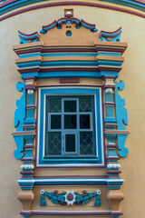 Window with beautiful carved concrete decorative trim, art in architecture