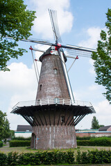 Traditional historic windmill in a residential area in the center of Oss in the Netherlands
