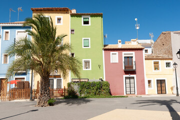 Landmark pastel colored homes and apartments along beach at La Vila Joiosa, Alicante Spain