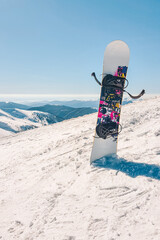 snowboard stick in snow mountains on background - obrazy, fototapety, plakaty