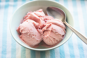 Strawberry ice creams scoops in blue bowl 