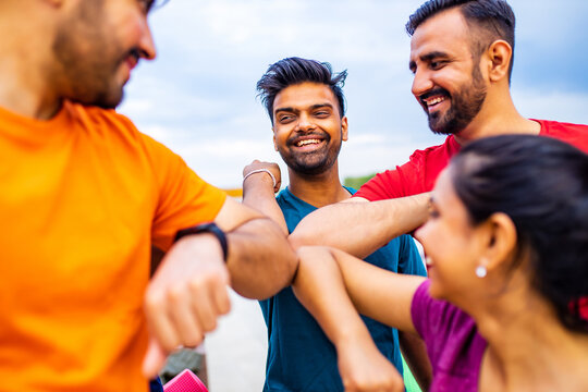 Young people friends bump their elbows to greeting