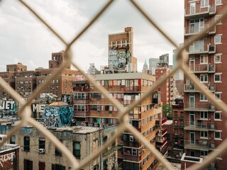 View of buildings in the Lower East Side covered in graffiti, from the Manhattan Bridge, New York...