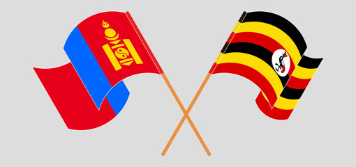 Crossed and waving flags of Mongolia and Uganda