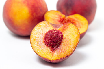 Peaches on a white background. Peach cut in half. Healthy diet.