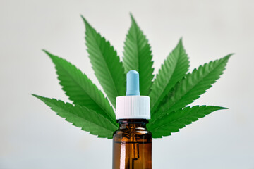 Bottle with cannabis or marijuana CBD oil on the white background. 