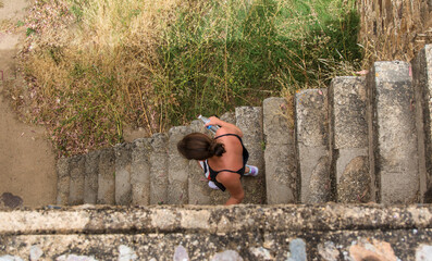 Aerial View Of A Woman Descending A Castle Stairs.Cenital plane